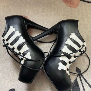 Iron Fist Black and White Skeleton Heels with Lace-Up Design